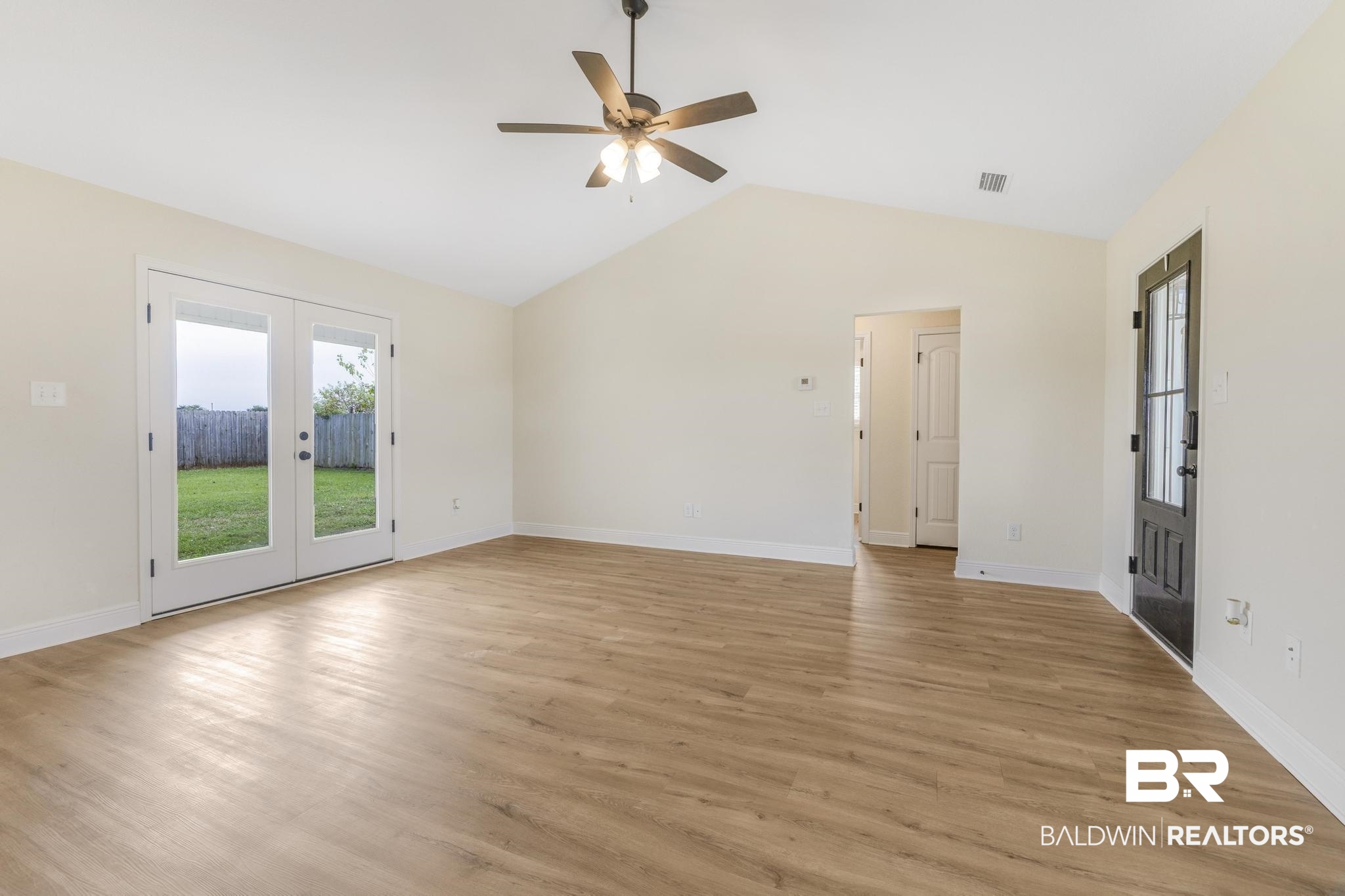 21580 Talbot Lane Robertsdale, AL 36567 - Photo 5 of 25 Unfurnished living room with french doors, lofted ceiling, light wood-style floors, and a ceiling fan