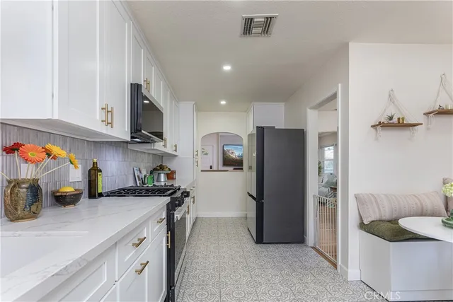 a kitchen with a sink and white cabinets