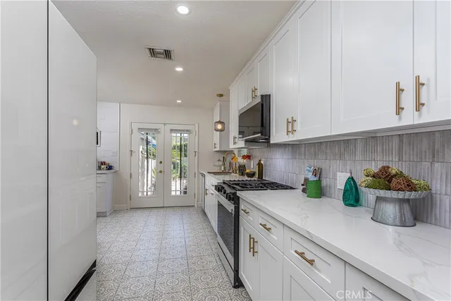 a kitchen with white cabinets and white appliances