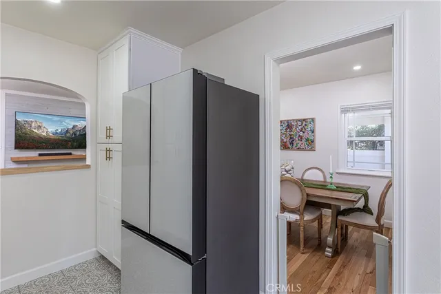 a view of a dining room with furniture and a chandelier
