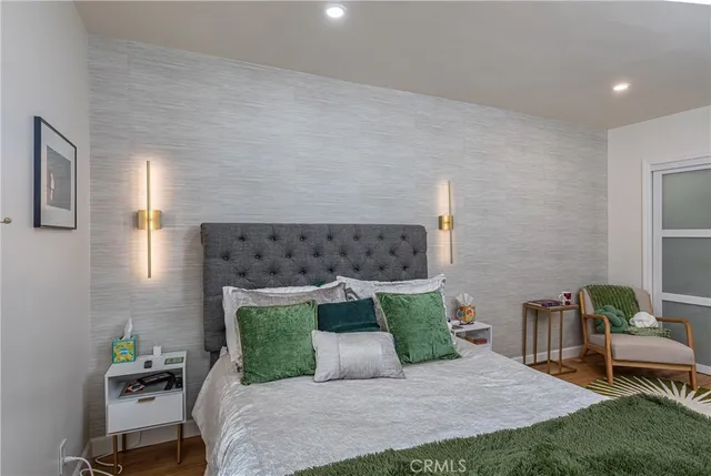 a bedroom with a bed and a chandelier