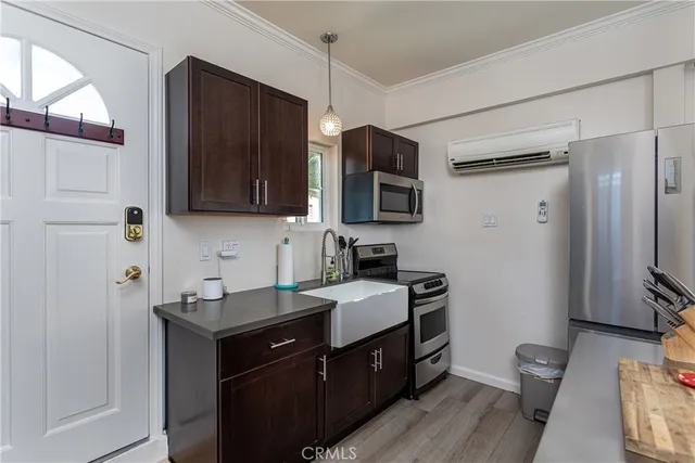 a living room with furniture a flat screen tv and a dining table