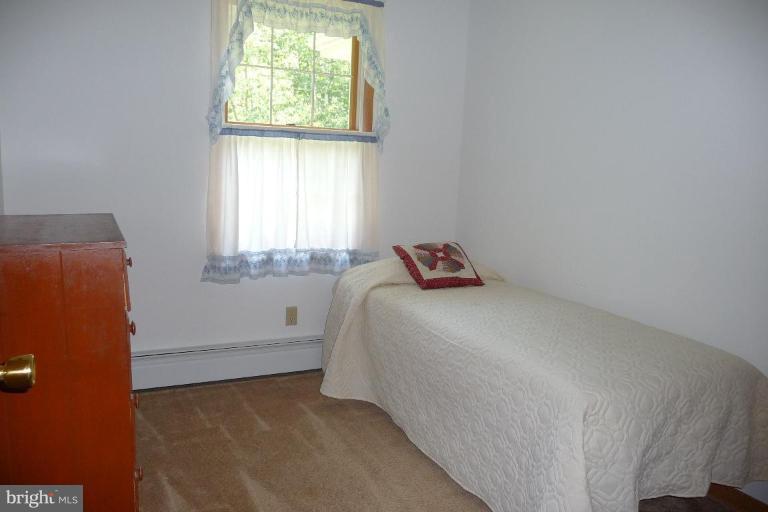 1130 Cox Road Huntingtown, MD 20639 - Photo 12 of 30 a bedroom with a bed and a window