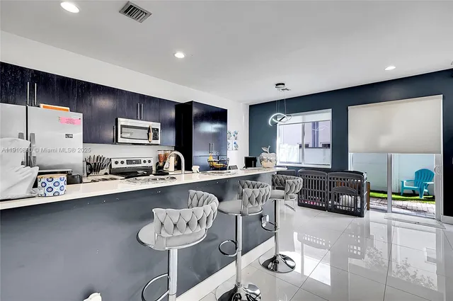 a kitchen with stainless steel appliances granite countertop a sink and cabinets