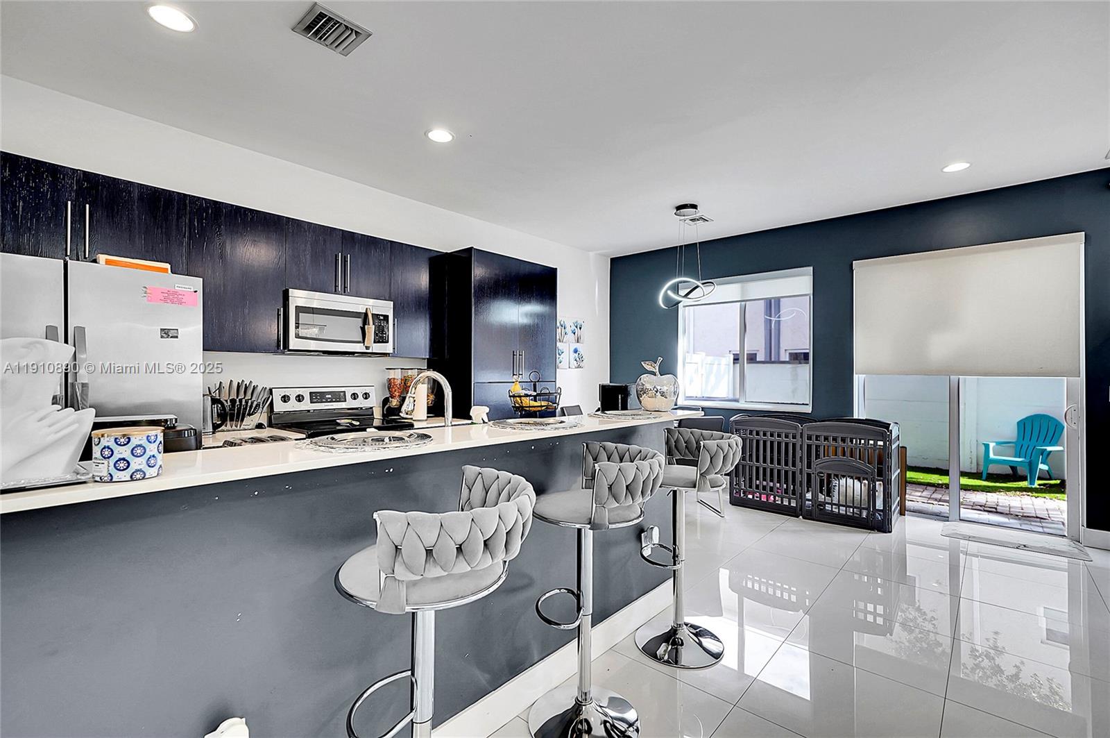 140 South E 7th Way Pompano Beach, FL 33060 - Photo 11 of 40 a kitchen with stainless steel appliances granite countertop a sink and cabinets
