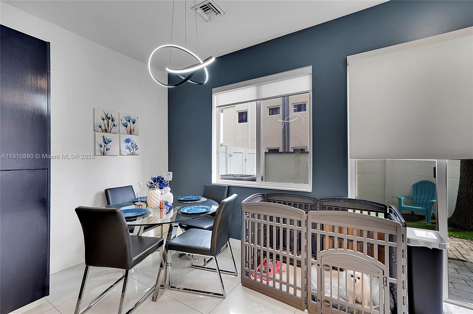 140 South E 7th Way Pompano Beach, FL 33060 - Photo 15 of 40 a bedroom with a bed and a chandelier