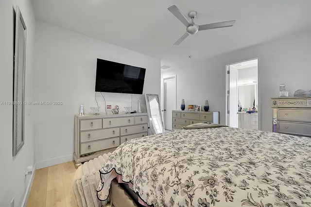 a large bedroom with a bed and a flat screen tv