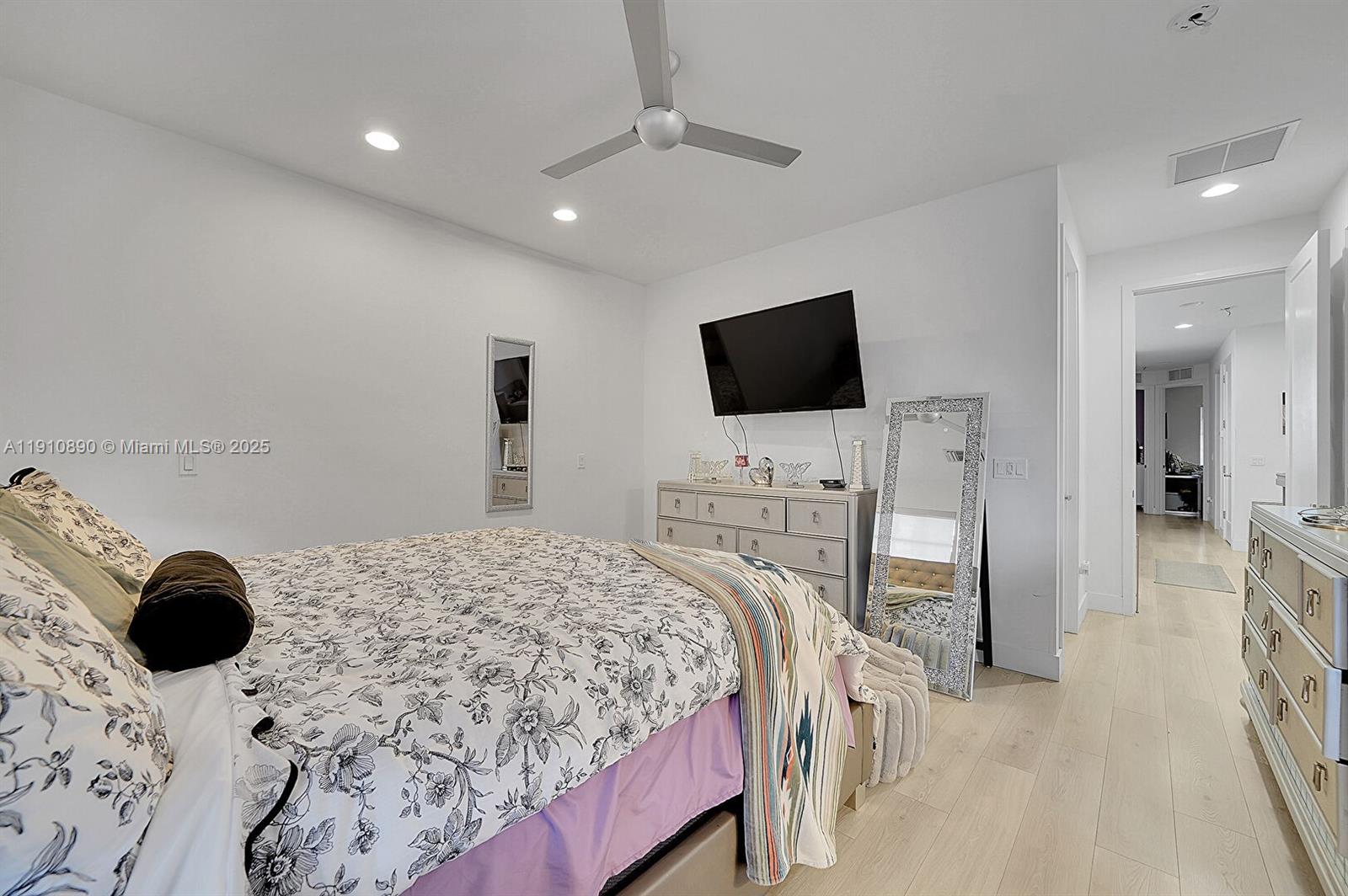 140 South E 7th Way Pompano Beach, FL 33060 - Photo 29 of 40 a bedroom with a bed and a flat screen tv