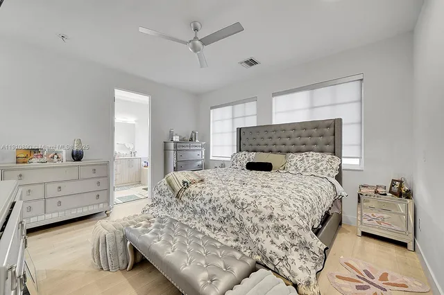 a bedroom with a large bed and dresser
