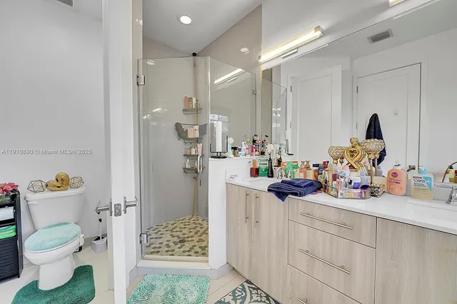 a view of bathroom with a sink toilet and shower