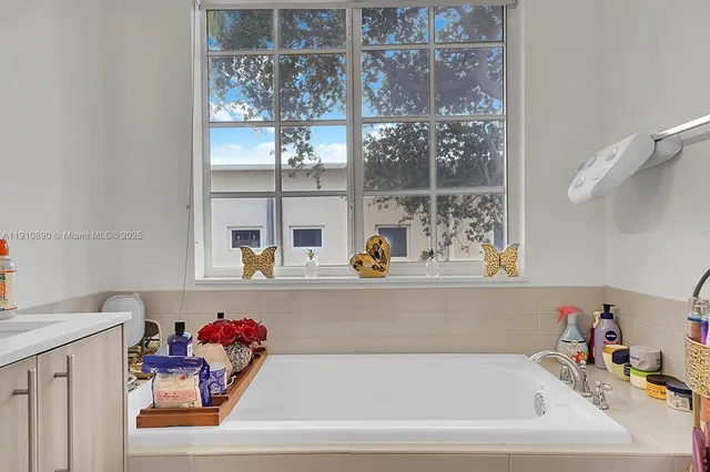 a bath tub sitting next to a shelf