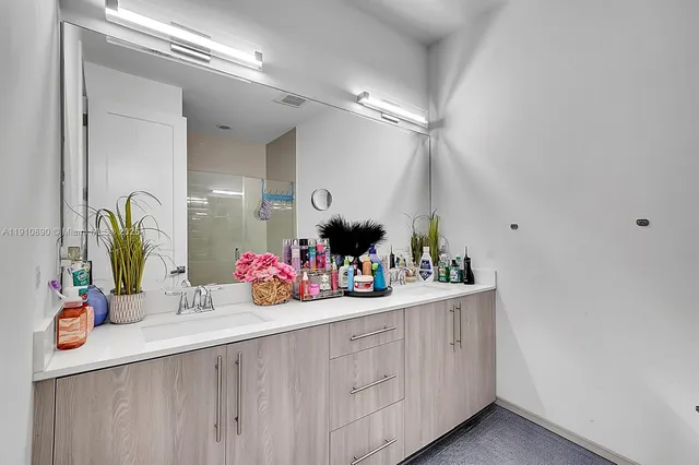 a bathroom with a sink vanity and mirror