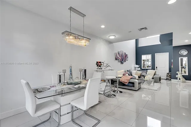 a living room with lots of furniture and view of kitchen