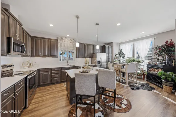 a kitchen with a table chairs stove and kitchen view