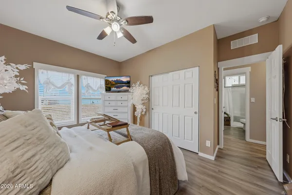 a bedroom with a bed and a chandelier