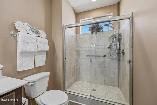 a bathroom with a shower and toilet