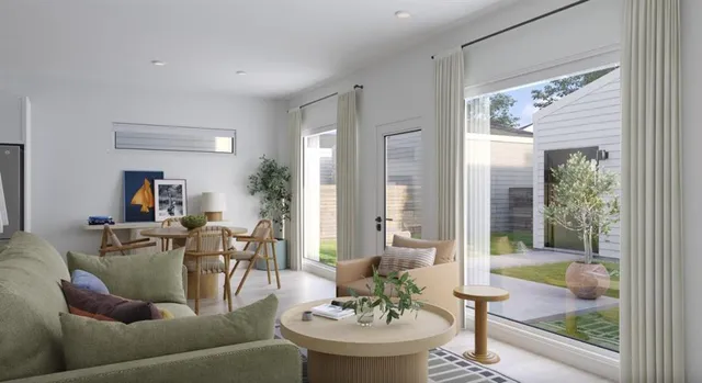 a kitchen with stainless steel appliances granite countertop a dining table chairs refrigerator and microwave