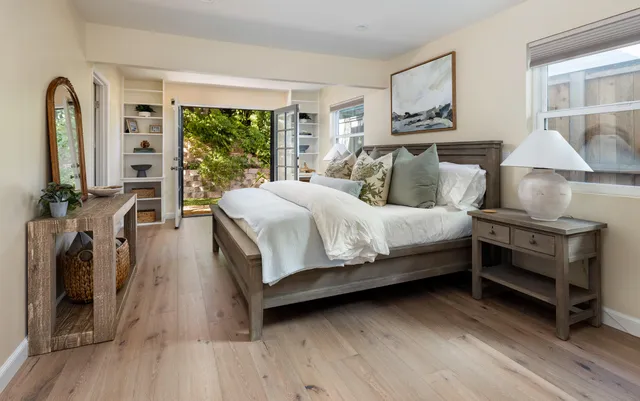 a view of a patio with a dining table and chairs under an umbrella