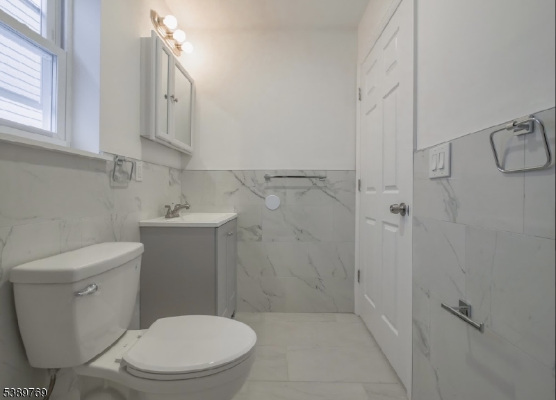 496 South 18th Street Newark, NJ 07103 - Photo 13 of 14 a white toilet sitting next to a bathroom sink