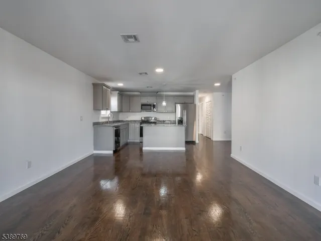 a view of a kitchen with cabinets and wooden floor