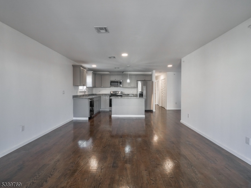 496 South 18th Street Newark, NJ 07103 - Photo 9 of 14 a view of a kitchen with cabinets and wooden floor