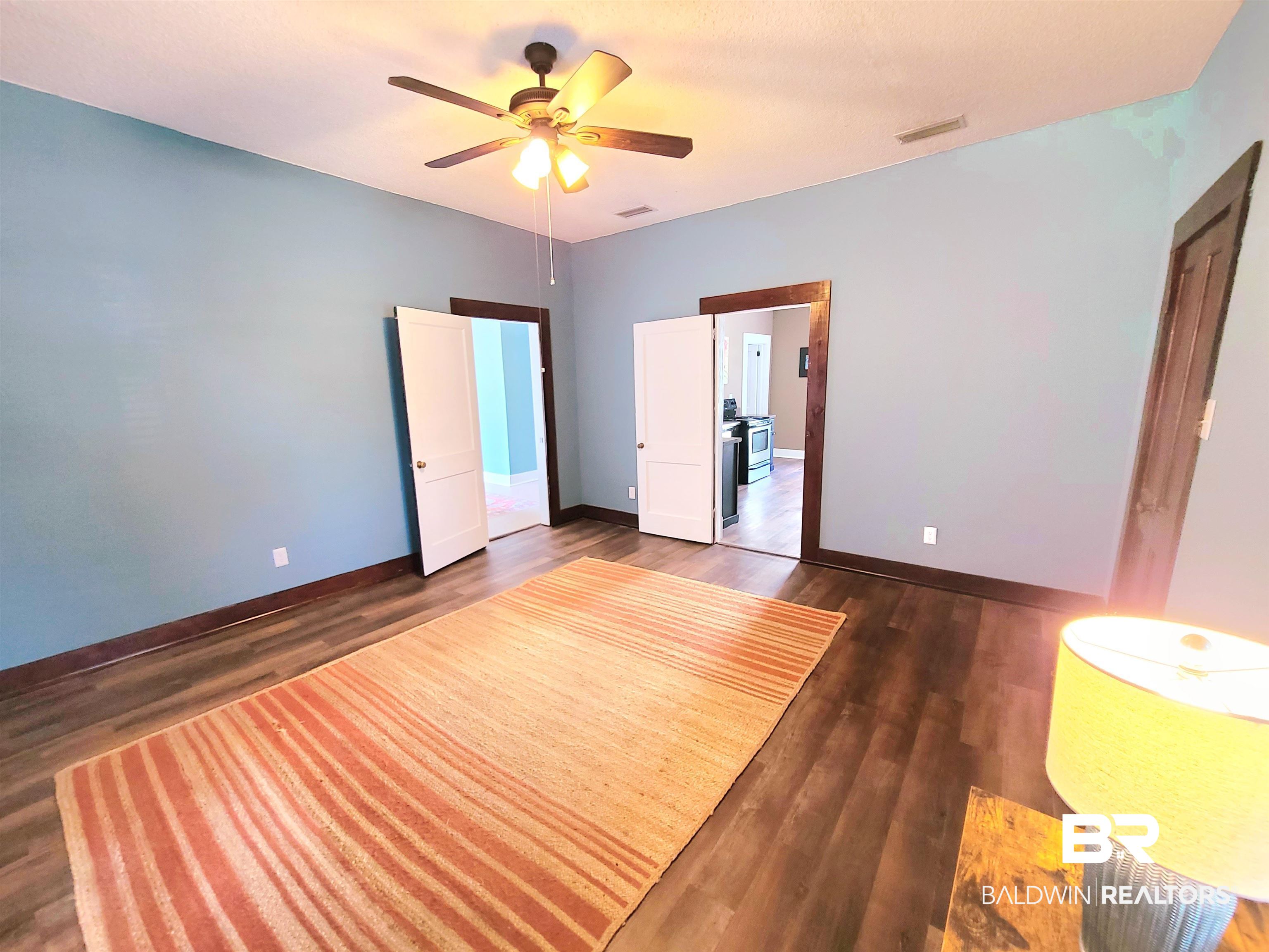 112 Espejo Street Mobile, AL 36604 - Photo 9 of 20 Unfurnished bedroom with baseboards, visible vents, ceiling fan, and dark wood-type flooring