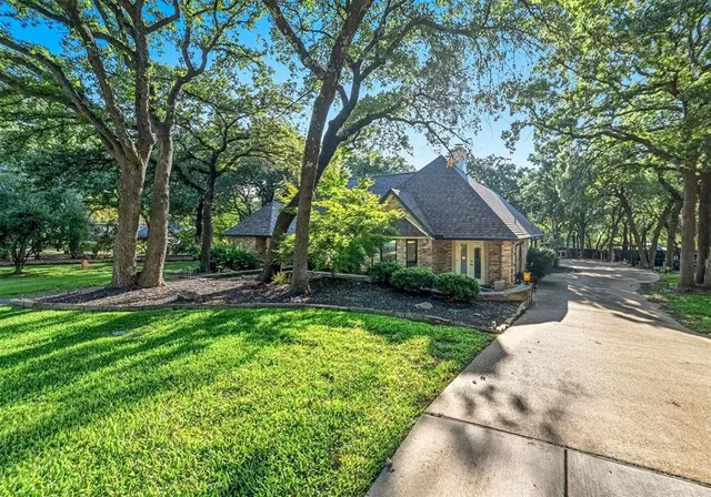 a view of house with yard and outdoor seating