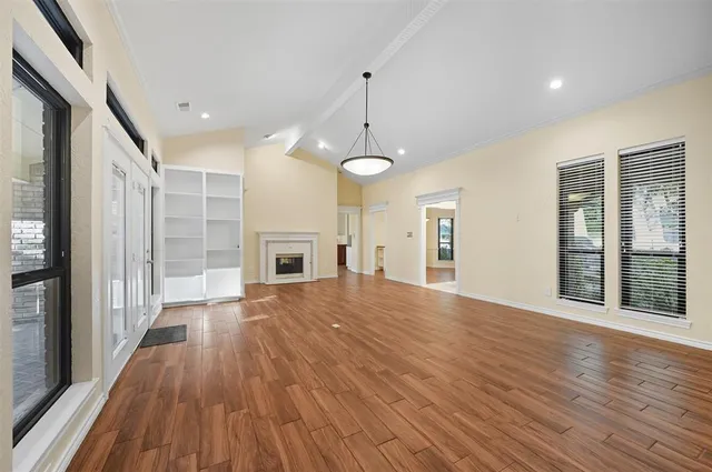 a view of open kitchen with granite countertop stainless steel appliances and wooden floor