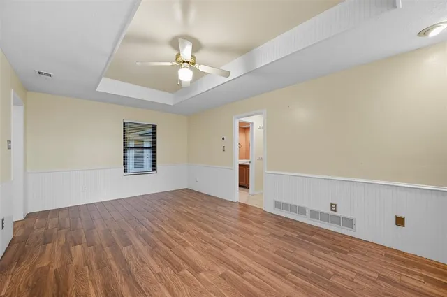 a large white kitchen with a large window