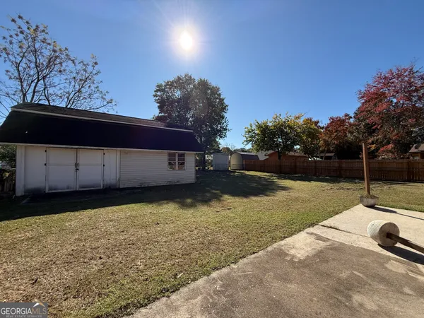 a view of a backyard with large trees
