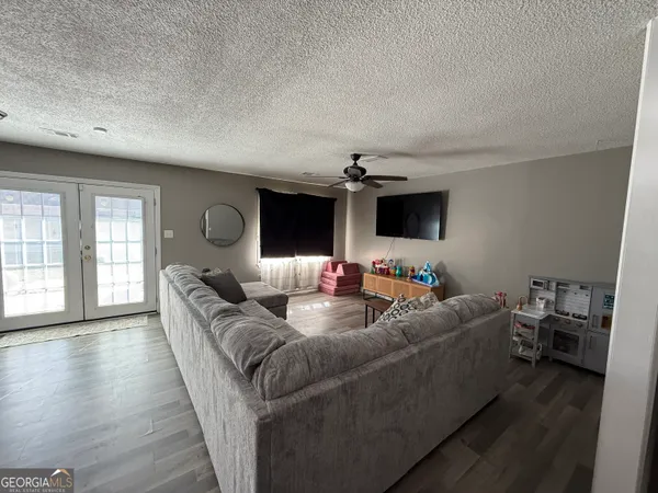 a living room with furniture and a flat screen tv