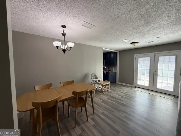 a view of a dining room with furniture and wooden floor