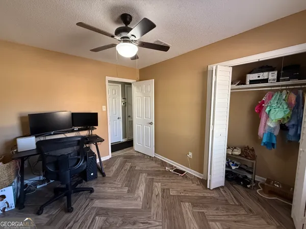 a view of a livingroom with workspace and a window