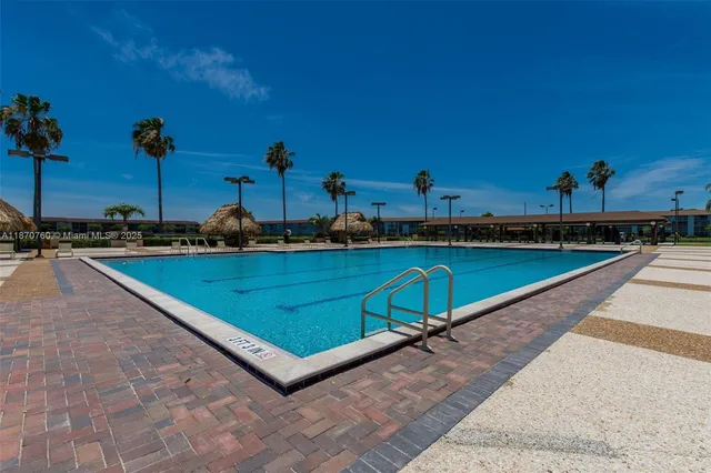 a swimming pool with outdoor seating and yard