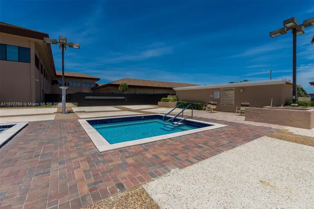 a view of a garden with a bench under an umbrella
