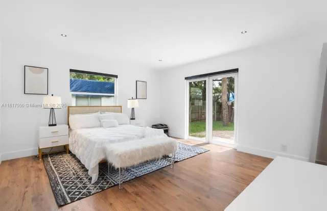 a bedroom with a large bed and a window