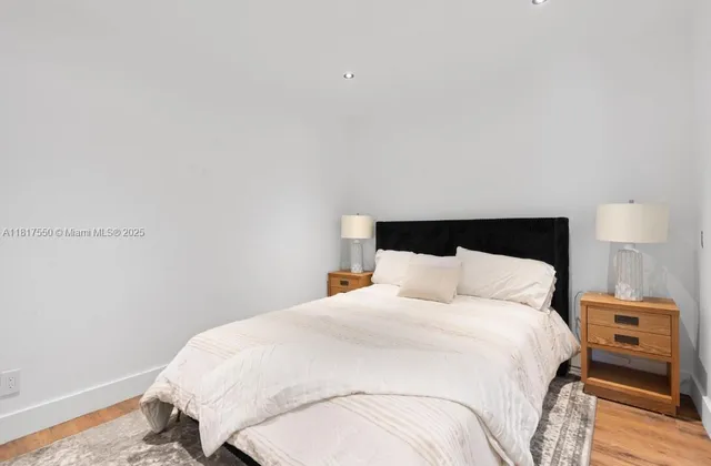 a bedroom with a bed and a night stand