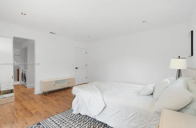 a bedroom with a bed and a couch