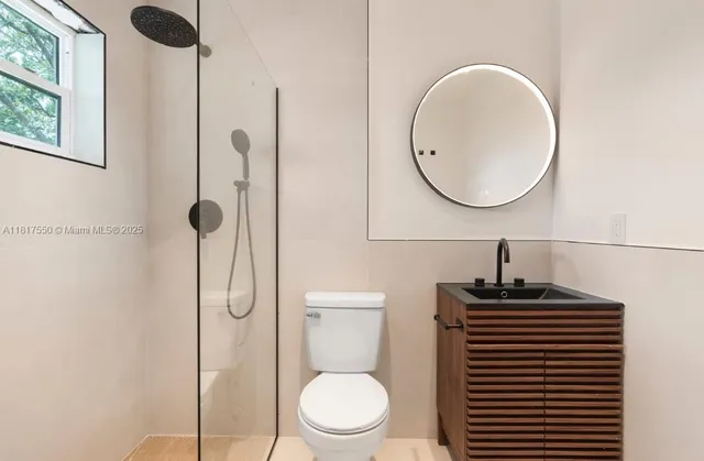 a bathroom with a toilet a sink and a mirror