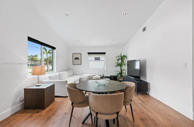 a dining room with furniture and wooden floor
