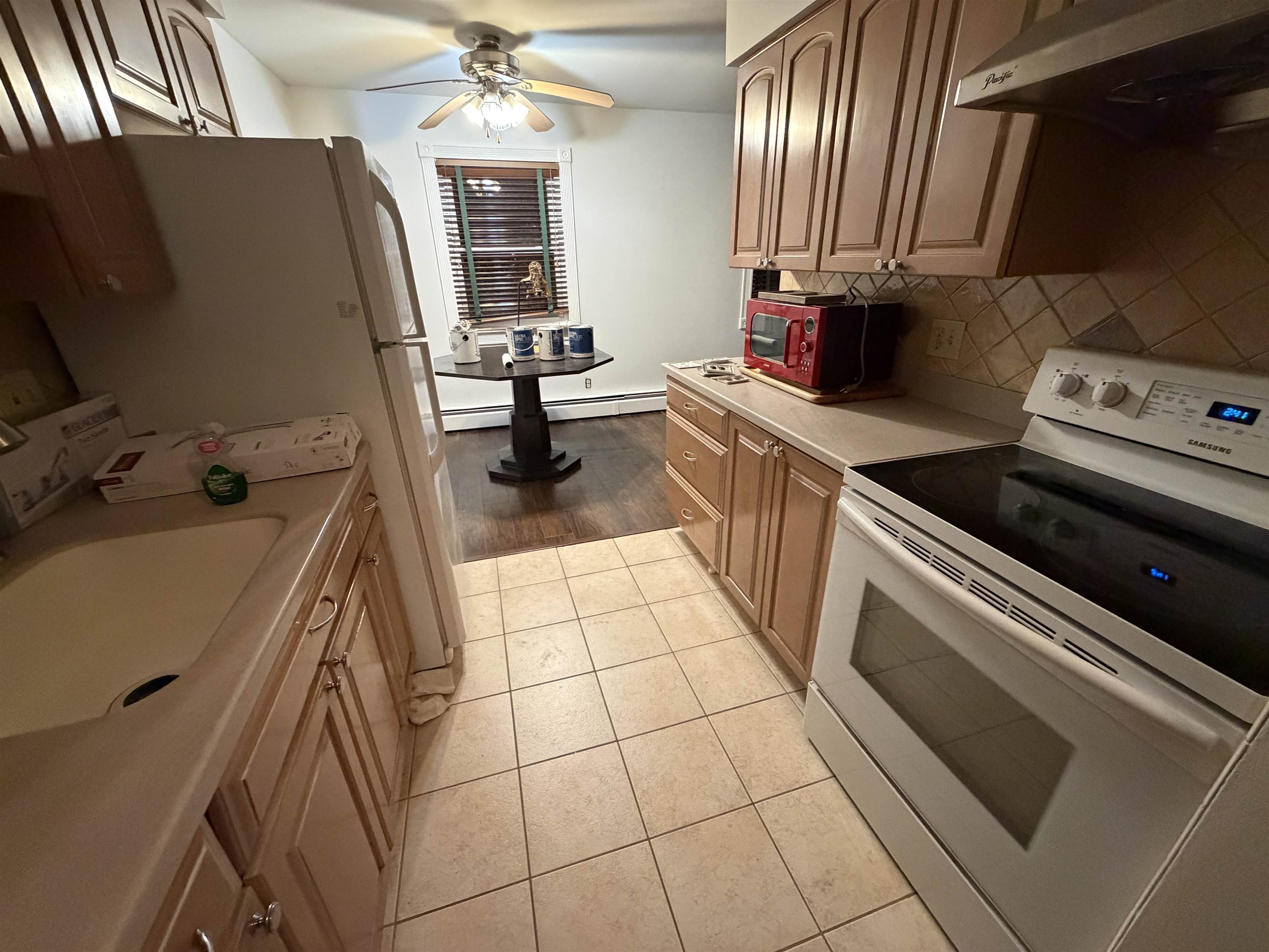 2 Radio Avenue, Unit A15 Secaucus, NJ 07094 - Photo 4 of 9 a kitchen with a sink appliances and cabinets