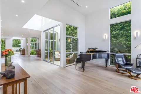 a living room with furniture and a floor to ceiling window