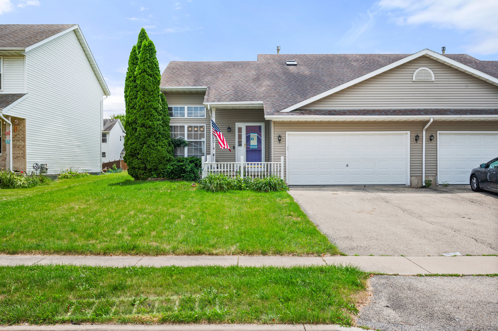 720 Hawthorne Lane Genoa, IL 60135 - Photo 1 of 25 a front view of a house with a garden and yard
