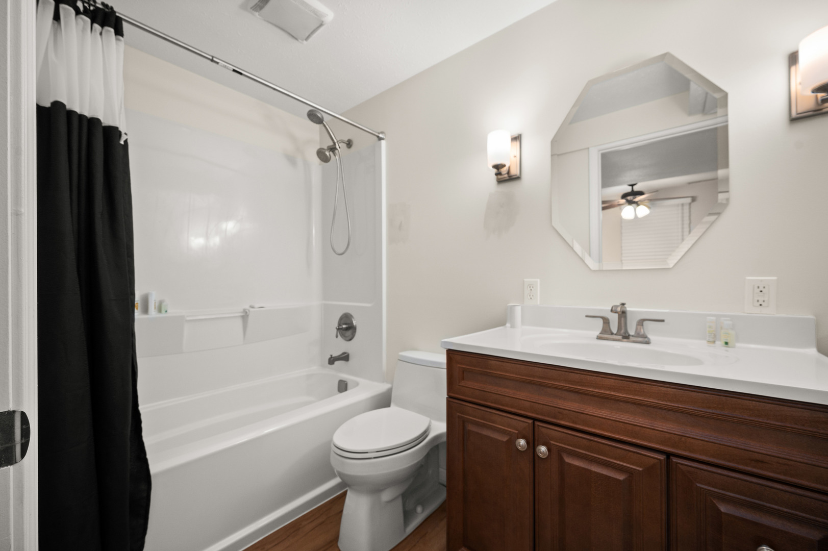 720 Hawthorne Lane Genoa, IL 60135 - Photo 20 of 25 a bathroom with a bathtub shower sink vanity mirror and toilet