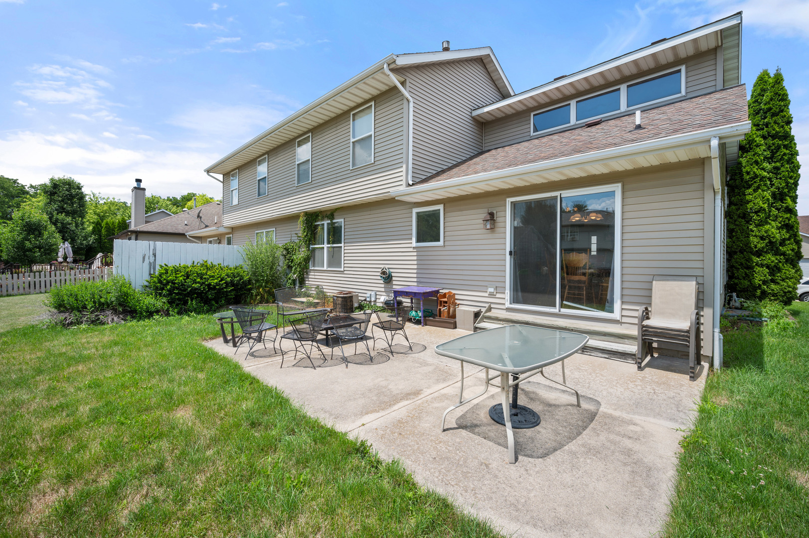 720 Hawthorne Lane Genoa, IL 60135 - Photo 23 of 25 a view of a patio with a table and chairs and potted plants