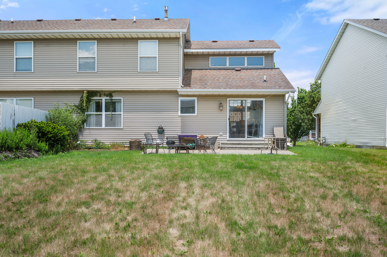 720 Hawthorne Lane Genoa, IL 60135 - Photo 24 of 25 a front view of a house with a garden