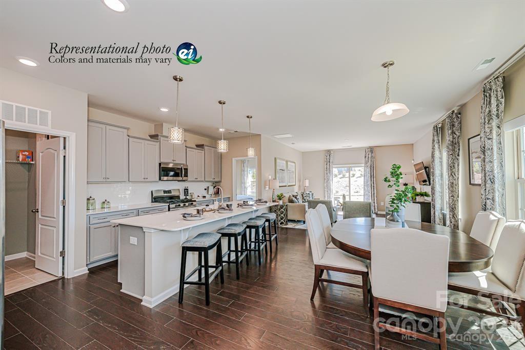 6587 Gopher Road, Unit 343 Lancaster, SC 29720 - Photo 12 of 19 a view of a dining room with furniture window and wooden floor
