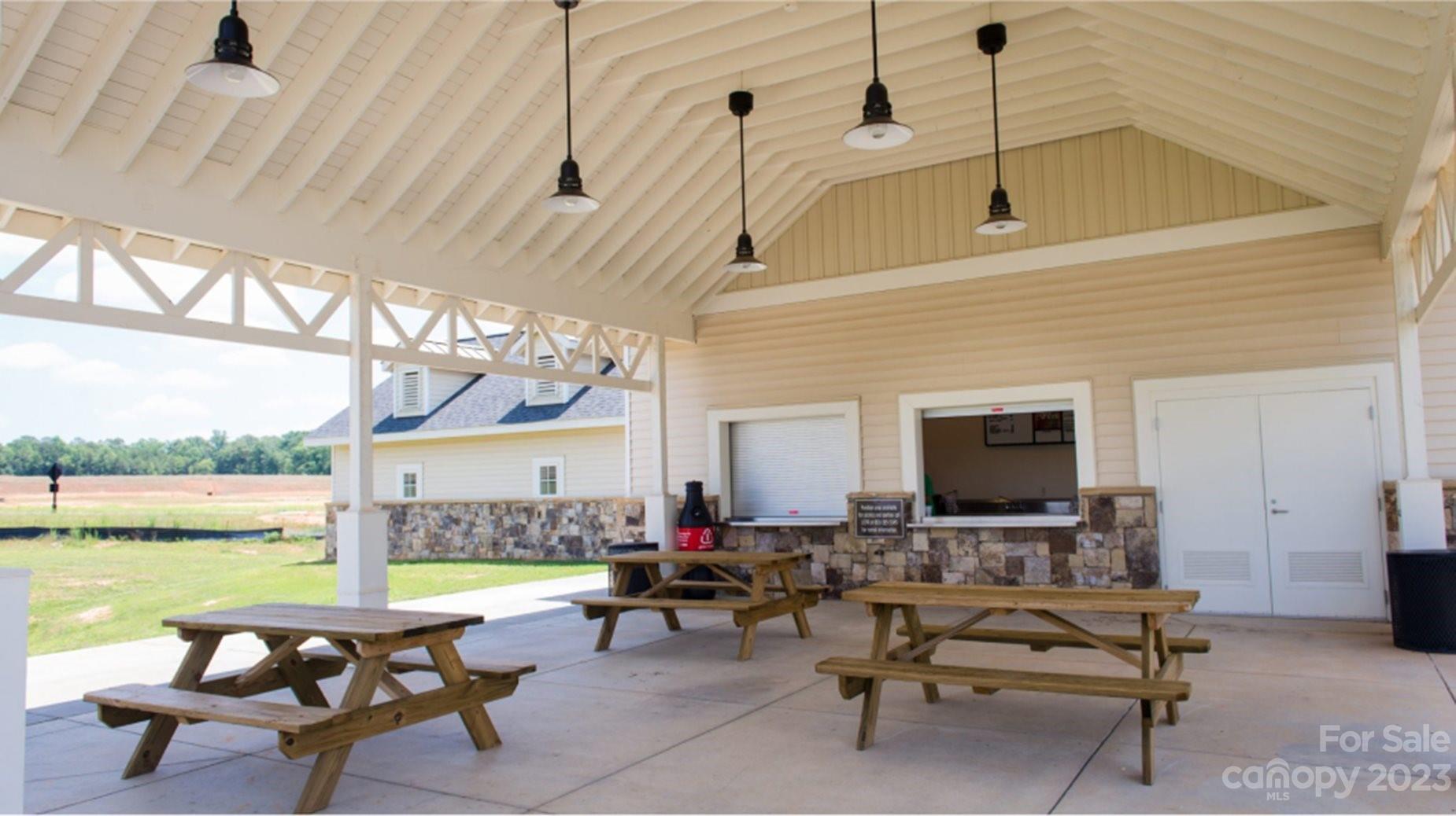 6587 Gopher Road, Unit 343 Lancaster, SC 29720 - Photo 14 of 19 a living room with patio furniture and a floor to ceiling window