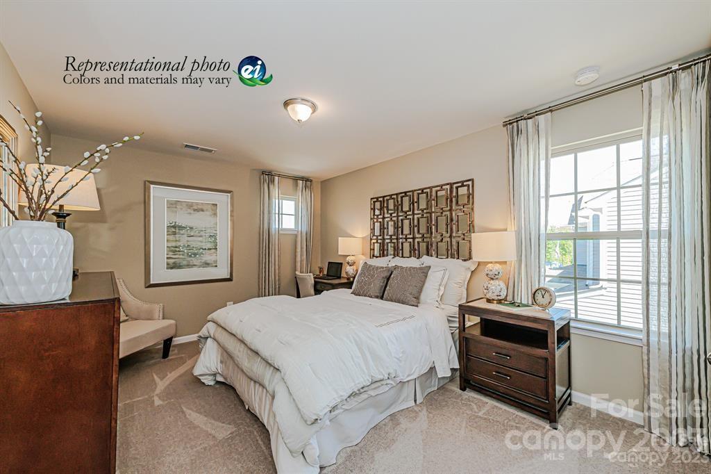 6587 Gopher Road, Unit 343 Lancaster, SC 29720 - Photo 8 of 19 a bedroom with a bed and wooden floor