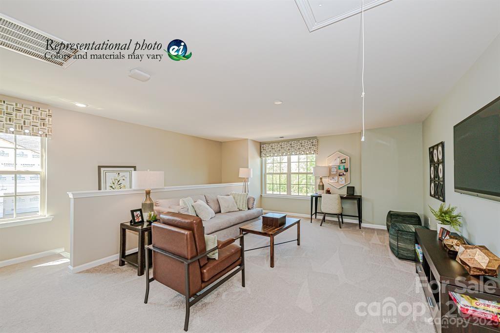 6587 Gopher Road, Unit 343 Lancaster, SC 29720 - Photo 10 of 19 a living room with furniture a window and a flat screen tv